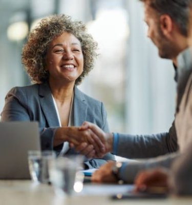 Happy multiracial businesswoman came to an agreement with her colleague during a meeting in the office.